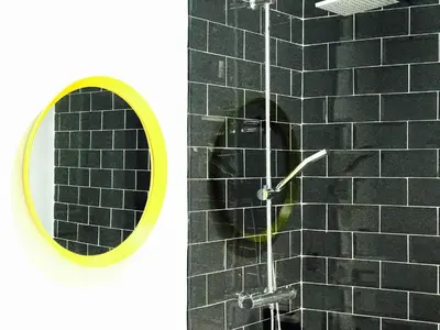 a shower with a mirror and a black tile wall at Casa Bolsa43 in Sanlúcar de Barrameda