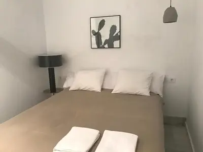 a bedroom with a bed with two white pillows at Casa Bolsa43 in Sanlúcar de Barrameda