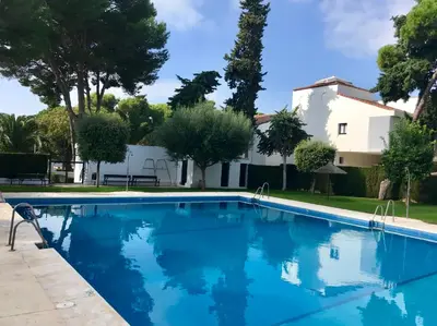 a swimming pool in front of a house at 'Sweet home' Loft con piscina en la mejor playa de El Puerto in El Puerto de Santa María