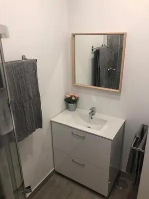 a bathroom with a sink and a mirror at 'Sweet home' Loft con piscina en la mejor playa de El Puerto in El Puerto de Santa María
