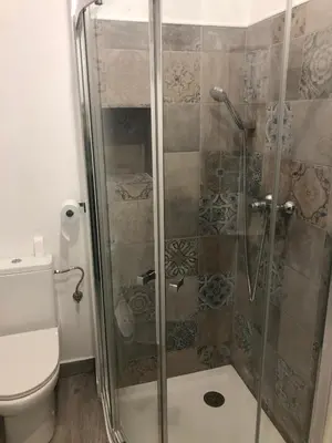 a bathroom with a shower and a toilet at 'Sweet home' Loft con piscina en la mejor playa de El Puerto in El Puerto de Santa María