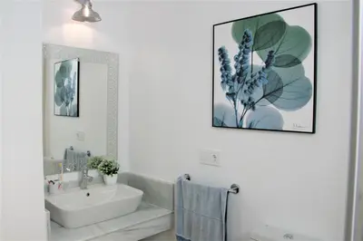 a white bathroom with a sink and a mirror at Enjoy Selecta Conil in Conil de la Frontera