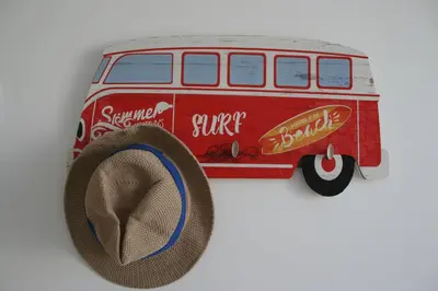 a hat is next to a red van toy at Enjoy Selecta Conil in Conil de la Frontera