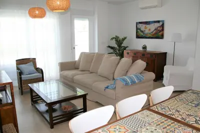 a living room with a couch and a table at Enjoy Selecta Conil in Conil de la Frontera