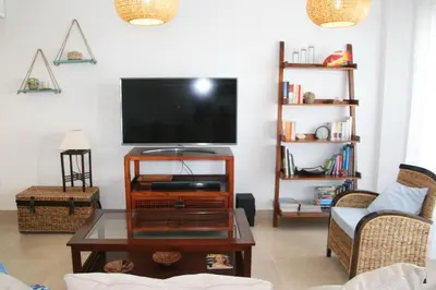 a living room with a tv and a coffee table at Enjoy Selecta Conil in Conil de la Frontera