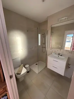 a bathroom with a shower and a toilet and a sink at Alojamiento Magallanes in Sanlúcar de Barrameda