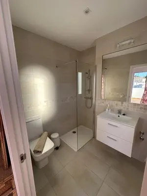 a bathroom with a shower toilet and a sink at Alojamiento Magallanes in Sanlúcar de Barrameda