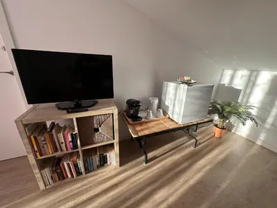 a living room with a flat screen tv on a entertainment center at Alojamiento Magallanes in Sanlúcar de Barrameda