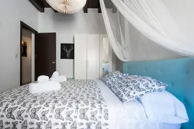 a bedroom with a large white bed with pillows at Apartamento Historico Garaje y WIFI in Sanlúcar de Barrameda