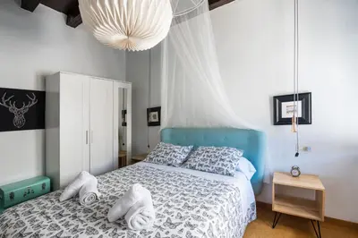 a bedroom with a blue bed with towels on it at Apartamento Historico Garaje y WIFI in Sanlúcar de Barrameda