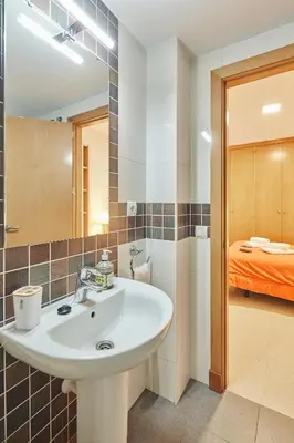 a bathroom with a sink and a bed at LA MÁS COQUETA, EN EL ADN DE CADIZ, in Cádiz
