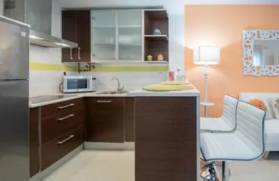 a kitchen with a sink and a microwave at LA MÁS COQUETA, EN EL ADN DE CADIZ, in Cádiz