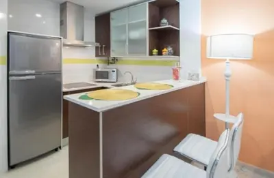 a kitchen with a sink and a refrigerator at LA MÁS COQUETA, EN EL ADN DE CADIZ, in Cádiz