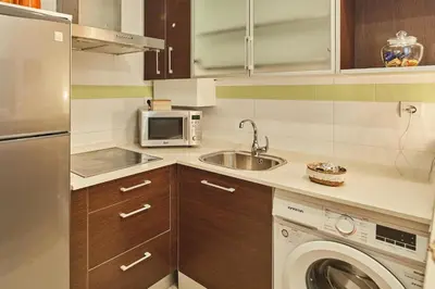 a kitchen with a sink and a washing machine at LA MÁS COQUETA, EN EL ADN DE CADIZ, in Cádiz