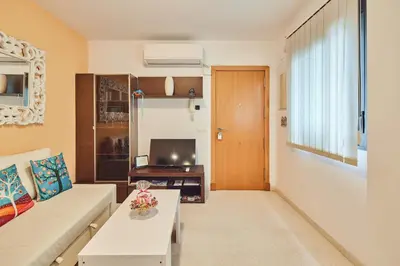a living room with a couch and a tv at LA MÁS COQUETA, EN EL ADN DE CADIZ, in Cádiz
