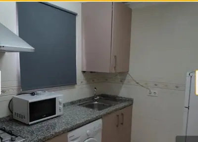 a kitchen and a living room with a table at PISO PLAZA CABECEO in Jerez de la Frontera