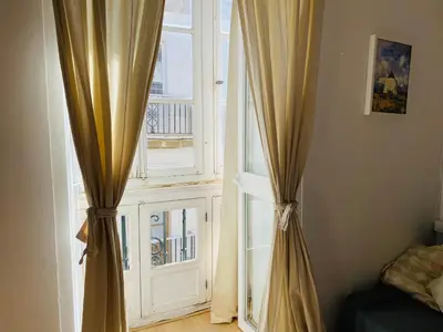 an open window with curtains in a room at Ático Cádiz Centro in Cádiz