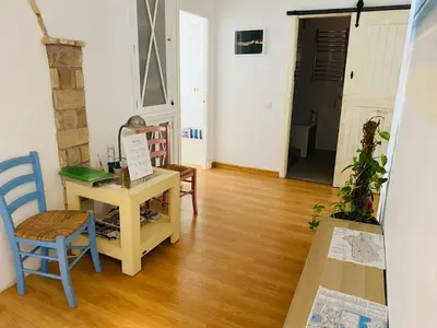 a room with a desk and a table and chairs at Ático Cádiz Centro in Cádiz