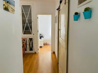 a hallway with a door leading to a living room at Ático Cádiz Centro in Cádiz