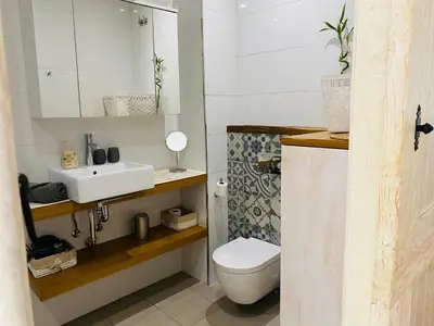 a bathroom with a sink and a toilet at Ático Cádiz Centro in Cádiz