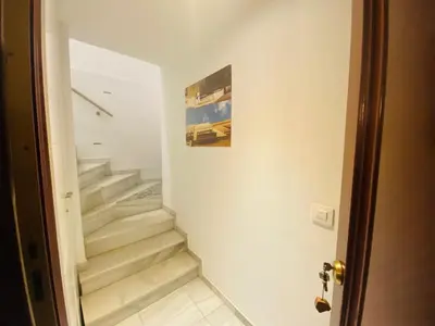 a hallway with stairs with a picture on the wall at Ático Cádiz Centro in Cádiz