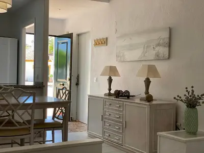 a living room with a desk and a table with two lamps at NOVO SANCTI PETRI - CASA CON ENCANTO in Novo Sancti Petri