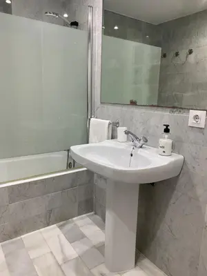a white bathroom with a sink and a mirror at NOVO SANCTI PETRI - CASA CON ENCANTO in Novo Sancti Petri