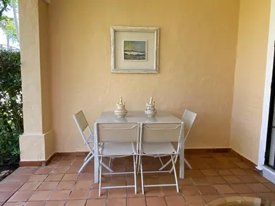 a table and chairs sitting on a patio at NOVO SANCTI PETRI - CASA CON ENCANTO in Novo Sancti Petri