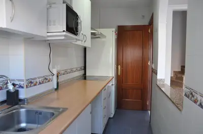 a kitchen with a sink and a microwave at Villachipi in Chipiona