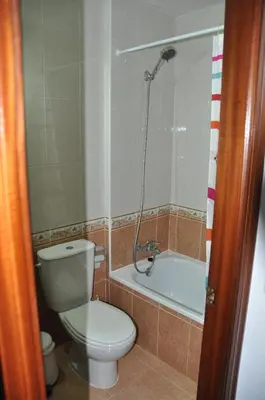 a bathroom with a toilet and a bath tub at Villachipi in Chipiona