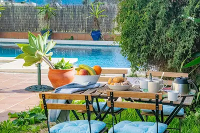 a table with fruit on it next to a pool at Villa Elissa with 3 bedrooms andpool and views close to Conil in Cádiz