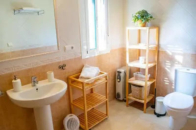 a bathroom with a sink and a toilet and a mirror at Villa Elissa with 3 bedrooms andpool and views close to Conil in Cádiz