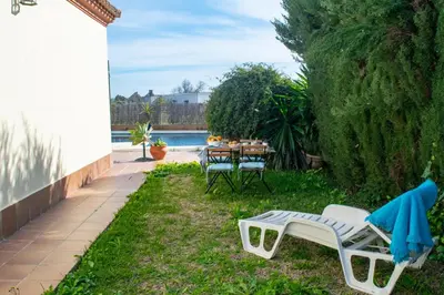 a patio with a table and chairs in the yard at Villa Elissa with 3 bedrooms andpool and views close to Conil in Cádiz