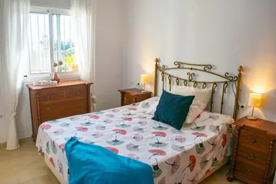 a bedroom with a bed and two night stands at Villa Elissa with 3 bedrooms andpool and views close to Conil in Cádiz