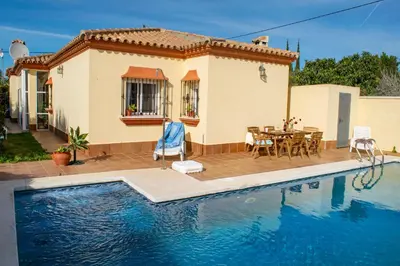 a villa with a swimming pool in front of a house at Villa Elissa with 3 bedrooms andpool and views close to Conil in Cádiz