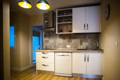 a kitchen with white cabinets and a sink at Santo Tomás A Ha Apartment in Cádiz