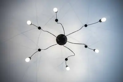 a chandelier with eight lights hanging from a ceiling at Santo Tomás A Ha Apartment in Cádiz