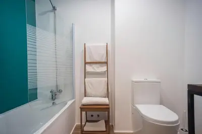 a bathroom with a toilet and a tub and a sink at Santo Tomás A Ha Apartment in Cádiz