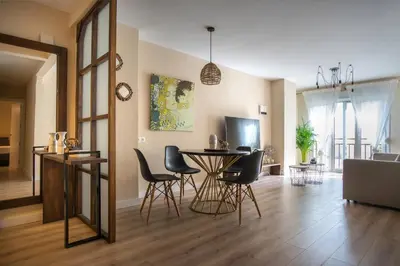 a living room with a table and chairs at Santo Tomás A Ha Apartment in Cádiz