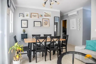 a dining room with a wooden table and black chairs at Casa Arcoiris by Cadiz Time in Cádiz