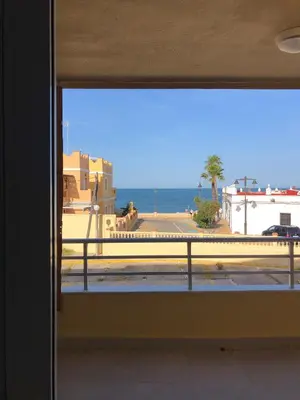 a view of the ocean from a window at Faro de chipiona in Chipiona
