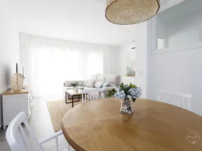 a living room with a table and a couch at La Fontanilla Place in Conil de la Frontera