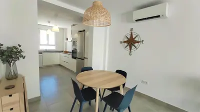 a kitchen and dining room with a table and chairs at La Fontanilla Place in Conil de la Frontera