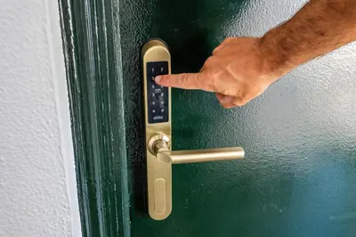 a persons hand reaching for a door handle on a door at Hotel Marhava in Conil de la Frontera