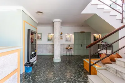 a room with a staircase and a column at Hotel Marhava in Conil de la Frontera