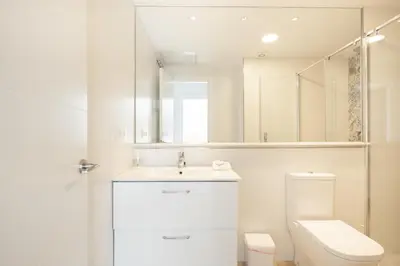 a bathroom with a toilet and a sink and a mirror at Apartamento Entrecatedrales 2 in Cádiz