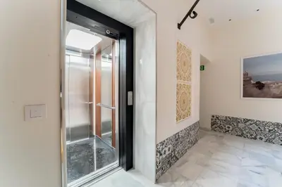 a glass door in a room with a tile floor at Apartamento Entrecatedrales 2 in Cádiz