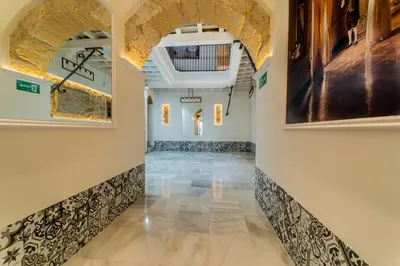 a hallway with arched ceilings and tile floors at Apartamento Entrecatedrales 2 in Cádiz
