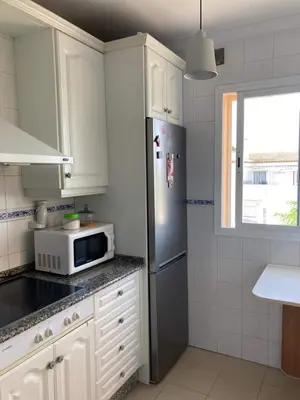 a kitchen with a refrigerator and a microwave at Apartamento Ailem in Novo Sancti Petri