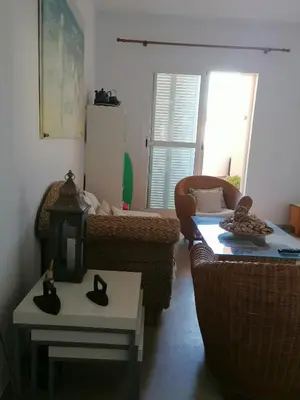 a living room with two couches and a table at Apartamento Ailem in Novo Sancti Petri